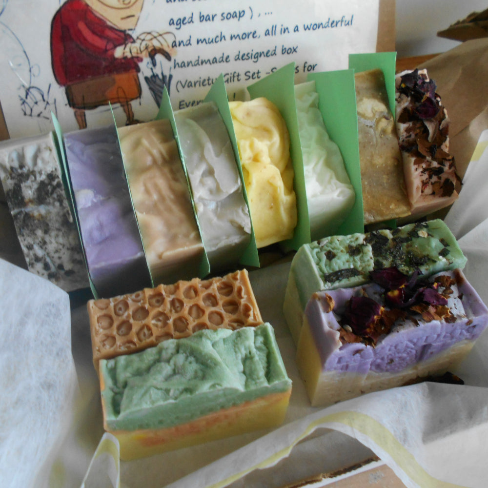Assorted bars of soap in green packaging with a variety of designs.