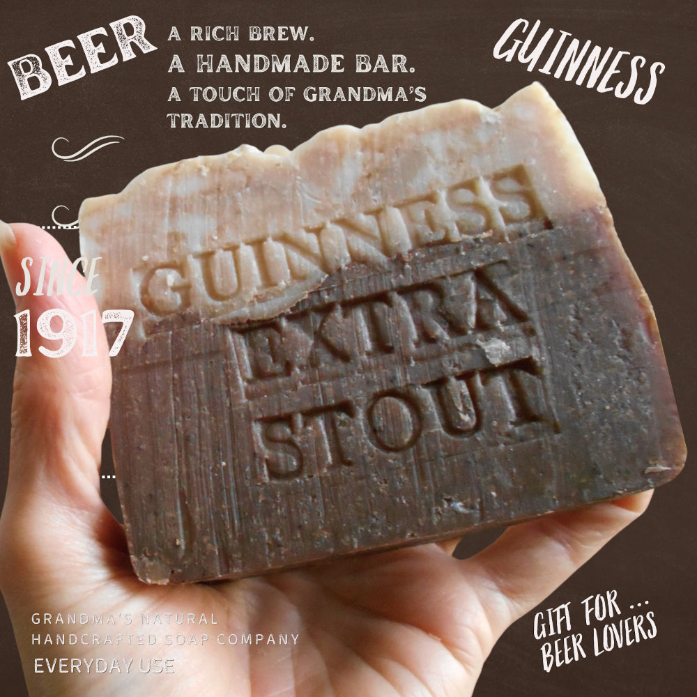 A hand holds a rustic handmade bar of Guinness Extra Stout soap against a dark brown background with vintage-style text overlays.