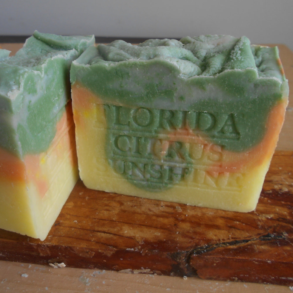Bar of soap with 'Florida Citrus Sunshine' text on a wooden surface