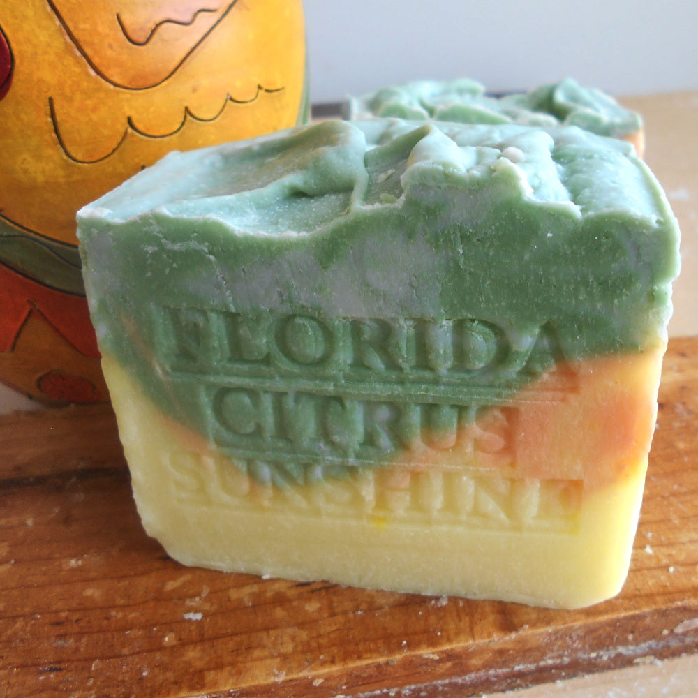 Bar of soap with 'Florida Citrus Sunshine' text on a wooden surface