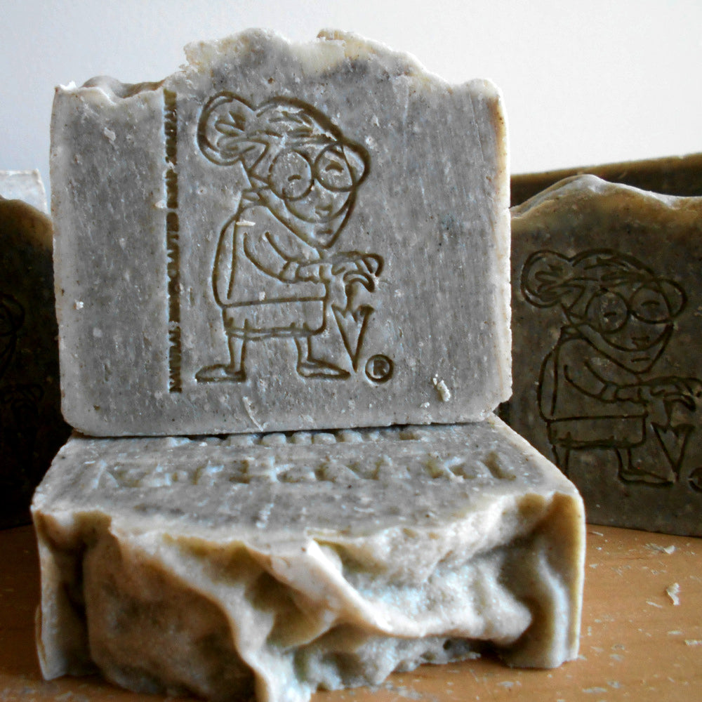 Dead Sea Mud Soap  with Grandmas stamp   embossed designs on a wooden surface