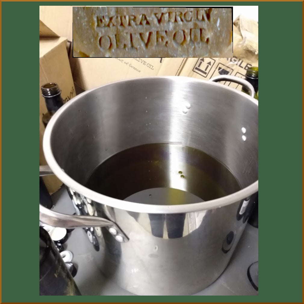 Metal pot with olive oil and a label reading 'Extra Virgin Olive Oil' in the corner.