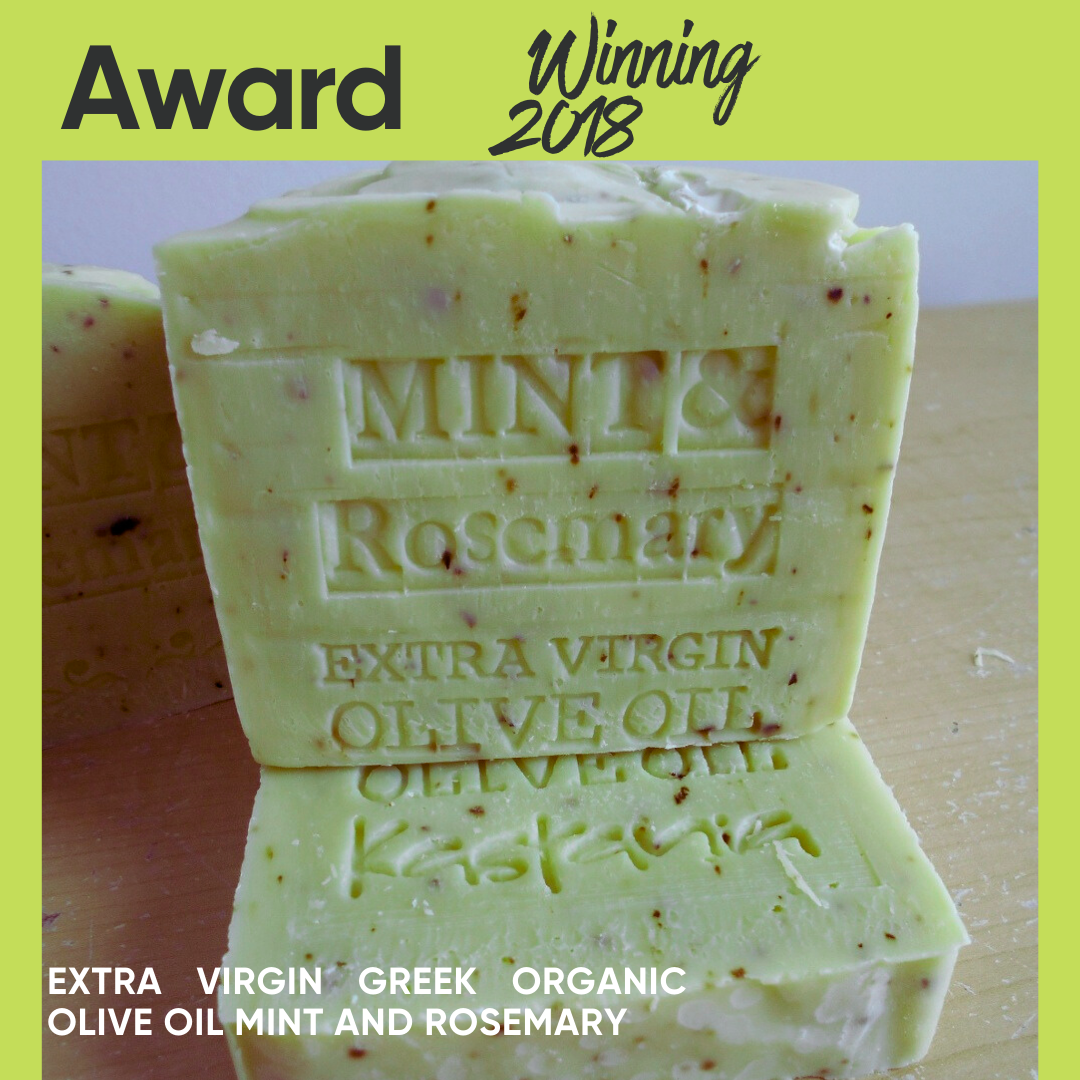 Award-winning mint and rosemary olive oil soap bars stacked on a wooden surface, with a lime green border and text overlays reading 'Award Winning 2018' and 'Extra Virgin Greek Organic Olive Oil Mint and Rosemary'.