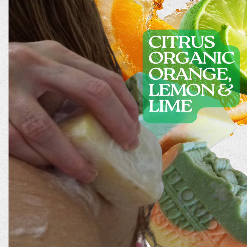 A showering with a citrus yellow soap bar to their shoulder, with citrus fruit slices and a green text label reading 'CITRUS ORGANIC ORANGE, LEMON & LIME' over the scene.