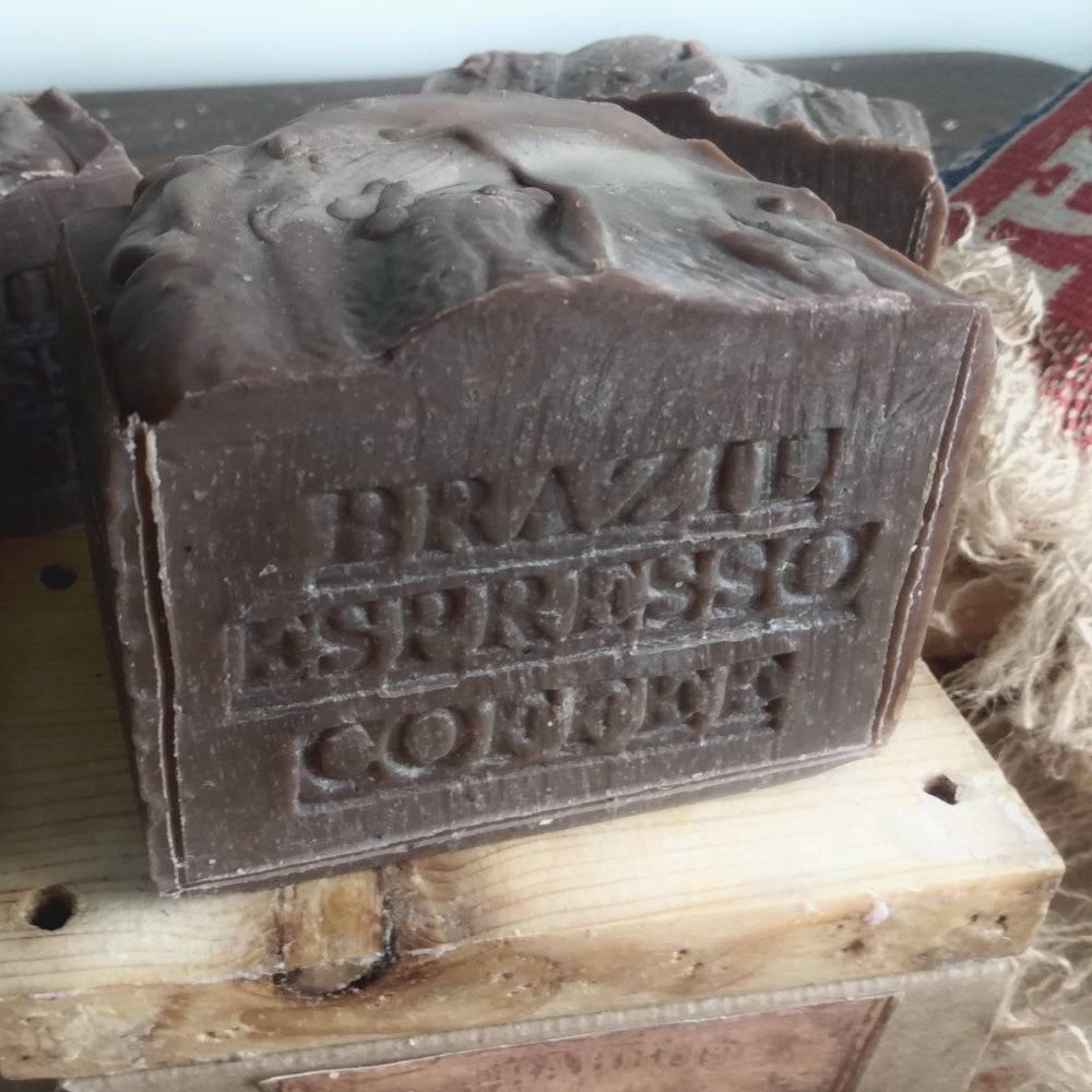 Brown soap bar with 'Brazilian Espresso Coffee' text on a wooden surface