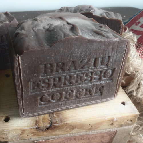 Brown soap bar with 'Brazilian Espresso Coffee' text on a wooden surface