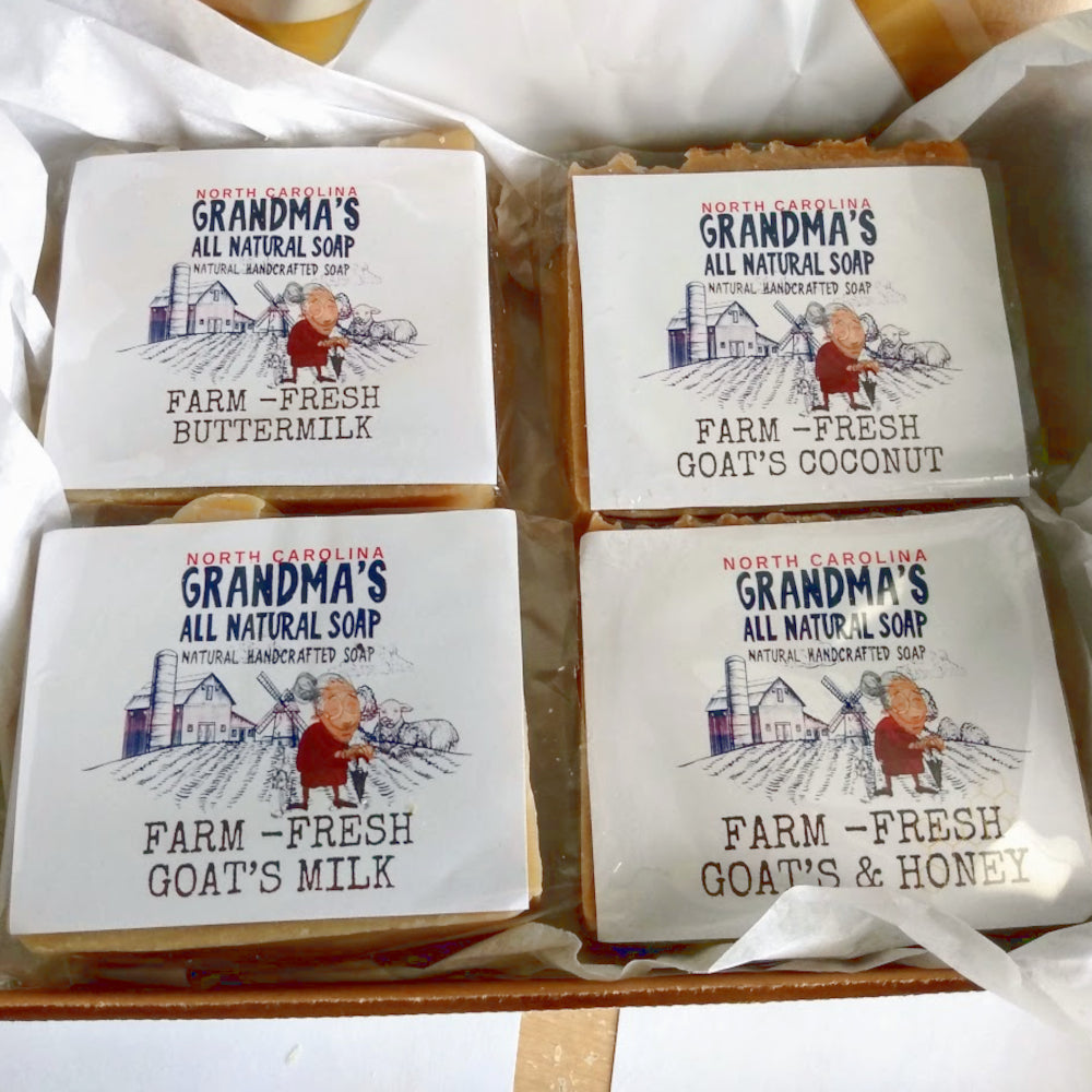 Four bars of soap from 'Grandma's All Natural Soap' with different scents on a white background.