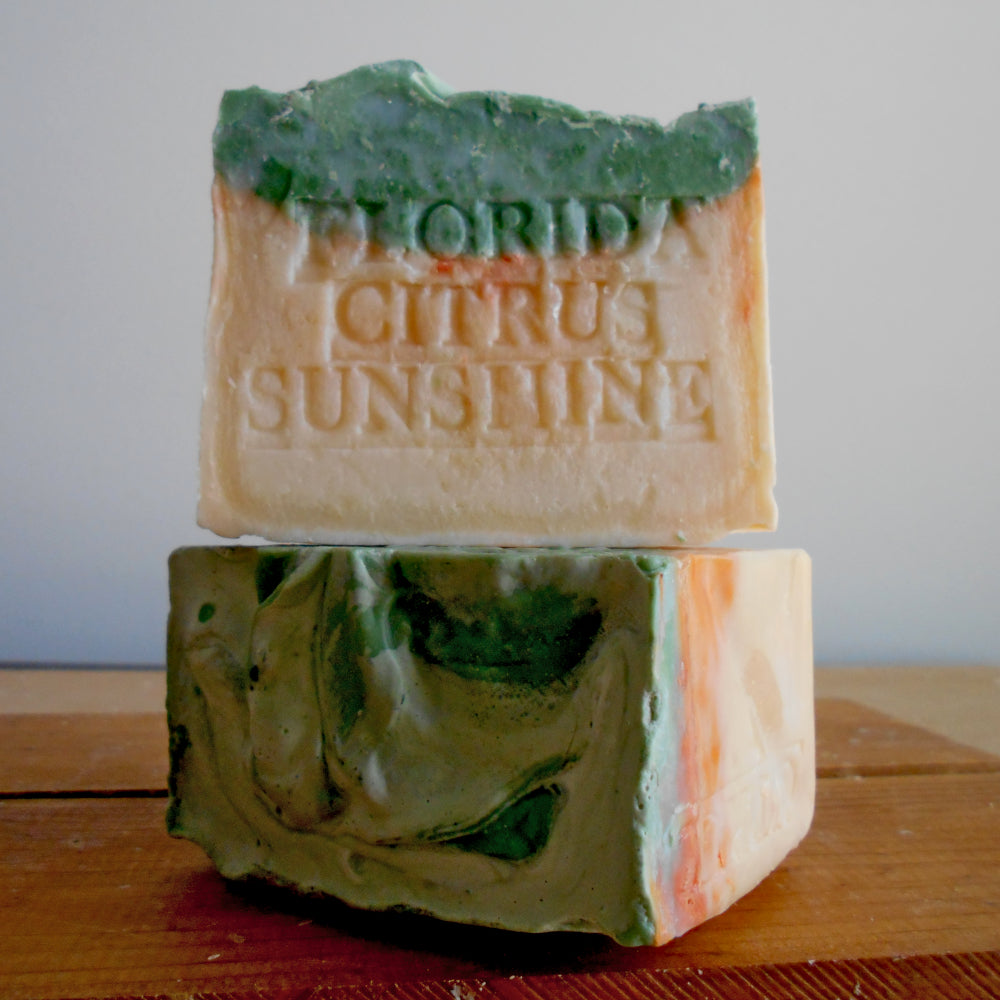Two bars of soap with 'Florida Citrus Sunshine' text on a wooden surface.