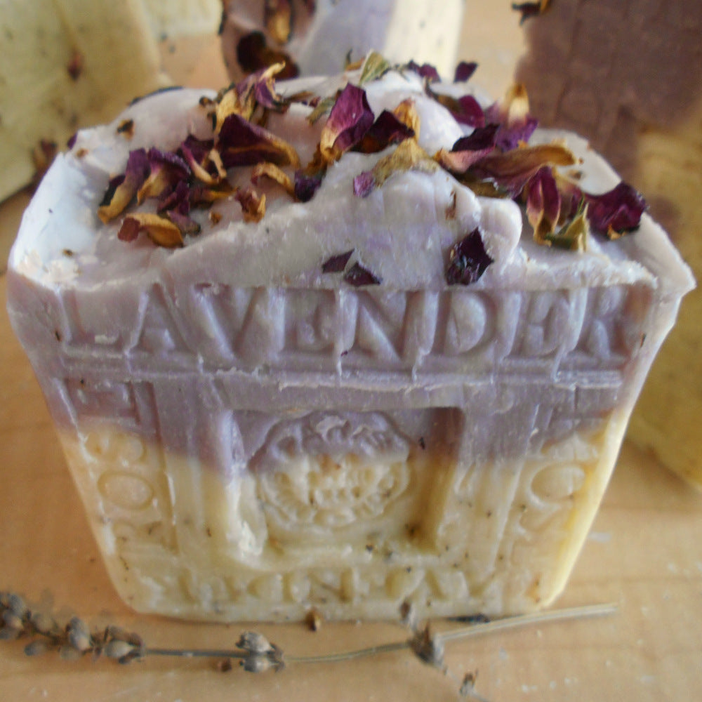 The Provence Lavender-Rose Soap - Large Aged Limited Edition by Grandmas All Natural Soap features hand-carved "LAVENDER," purple and cream layers, dried flower petals on top, and sprigs of lavender for a French-inspired touch.