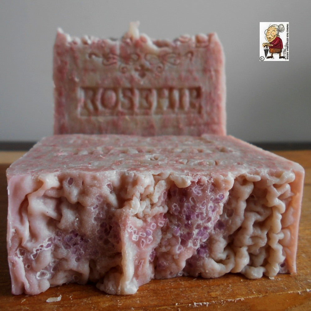 A Handcrafted  Rosehip Soap with olive oil  There is a small logo in the top right corner